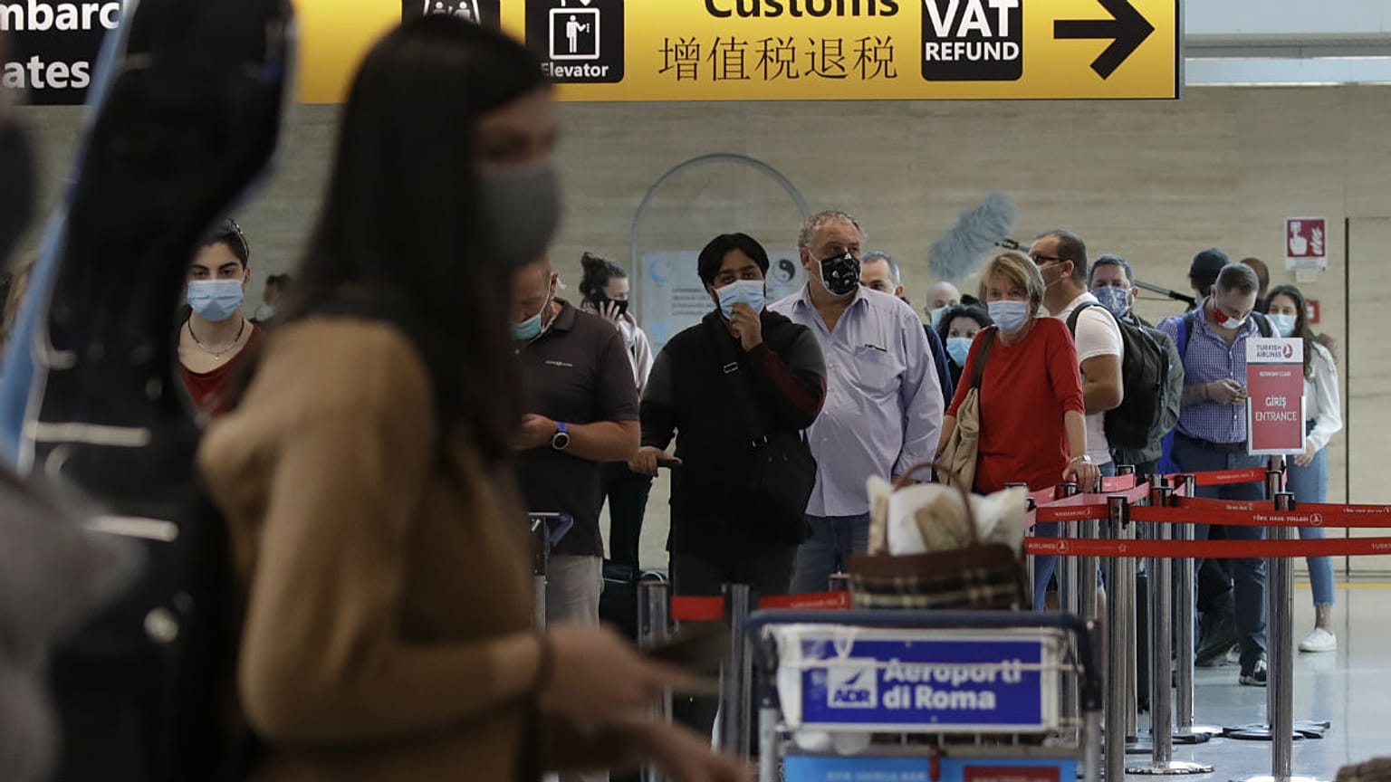 People wait in line at the check in at Rome's Fiumicino airport