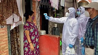 health workers going door-to-door and conducting temperature screening of residents