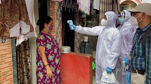 health workers going door-to-door and conducting temperature screening of residents