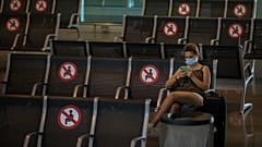 A passenger sits at Barcelona airport in Barcelona, Spain