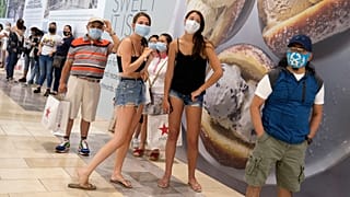 Customers wait in line to enter a store in New Jersey