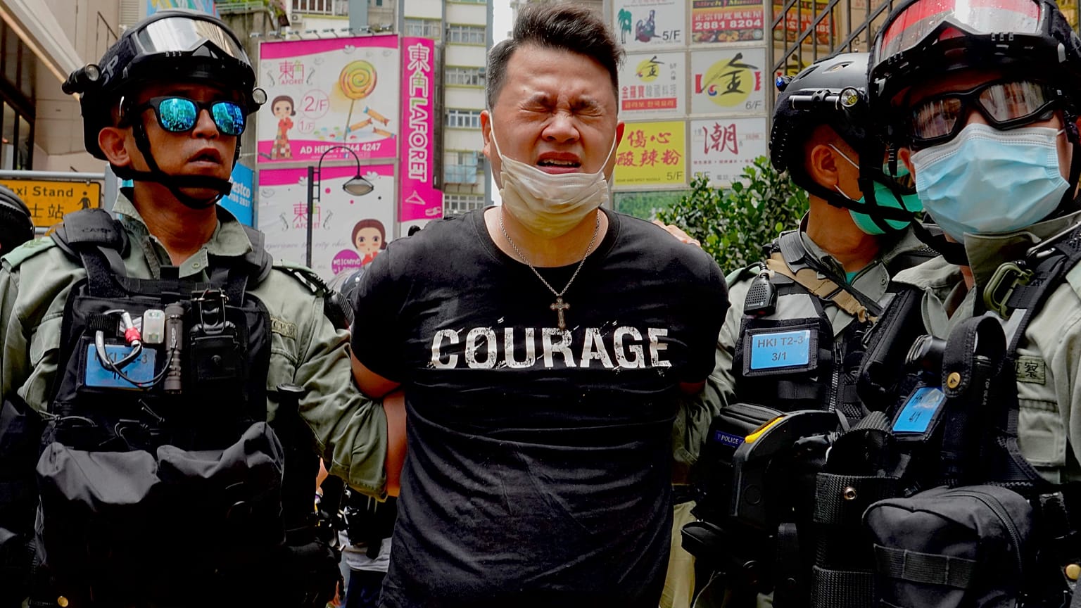 Police detain a protester after spraying pepper spray during a protest in Causeway Bay before the annual handover march in Hong Kong, Wednesday, July. 1, 2020. 