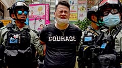 Police detain a protester after spraying pepper spray during a protest in Causeway Bay before the annual handover march in Hong Kong, Wednesday, July. 1, 2020. 