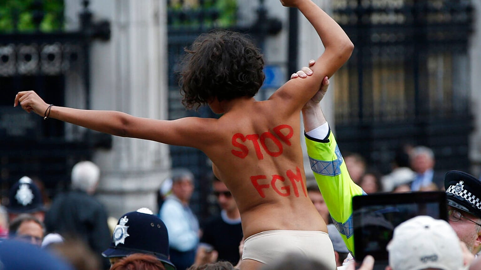A FEMEN activist shouts slogans against female genital mutilation (FGM) during a protest opposite the Houses of Parliament in London.