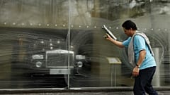 A window cleaner works on a window at a Rolls-Royce showroom in London
