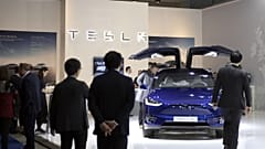 People view the new Tesla Model X during the Brussels Auto Show at the Expo in Brussels, Thursday, Jan. 9, 2020.