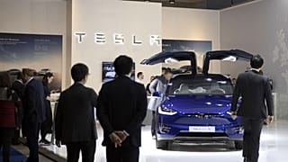 People view the new Tesla Model X during the Brussels Auto Show at the Expo in Brussels, Thursday, Jan. 9, 2020.