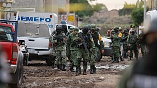 Members of the national guard walk near an unregistered drug rehabilitation center in Irapuato, Mexico, Wednesday, July 1, 2020.