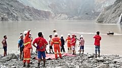 Myanmar Fire Services Department rescuers attempting to locate survivors after a landslide at a jade mine on July 2, 2020.
