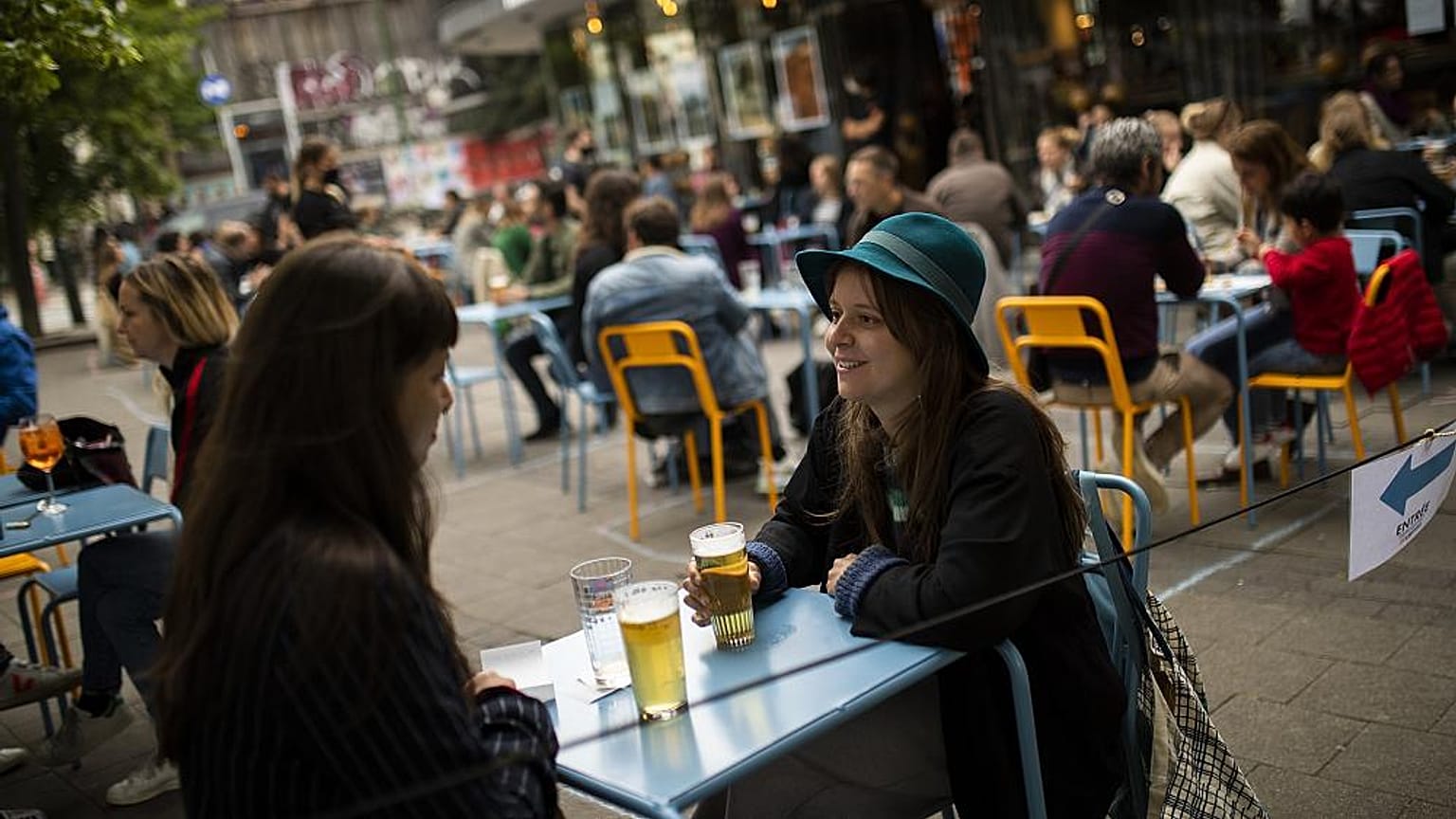 European tourists drinks beers at the terrace of the Bar du Matin restaurant in Brussels