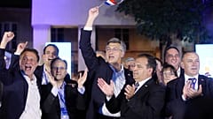 Croatia's Prime Minister incumbent Andrej Plenkovic (holding a Croatian flag) celebrates victory at the Archaeological Museum in Zagreb, on July 5. 2020.