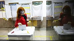 A voter wearing a face mask casts her ballot in Moscow, Russia. Russians vote on a constitutional reform that would allow President Vladimir Putin to stay in power until 2036