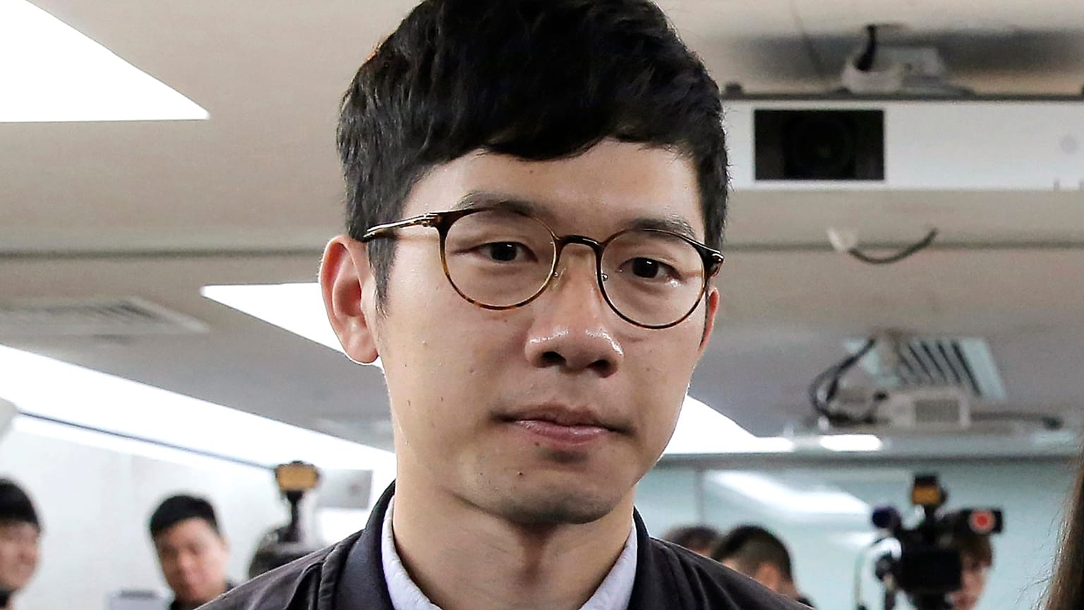 In this Jan. 27, 2018, file photo, pro-democracy activist Nathan Law attends a press conference in Hong Kong. He has now left the city for an undisclosed location.