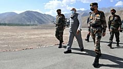 In this handout photo provided by the Press Information Bureau, Indian Prime Minister Narendra Modi walks with soldiers during a visit to the Ladakh area, India, Friday, July 