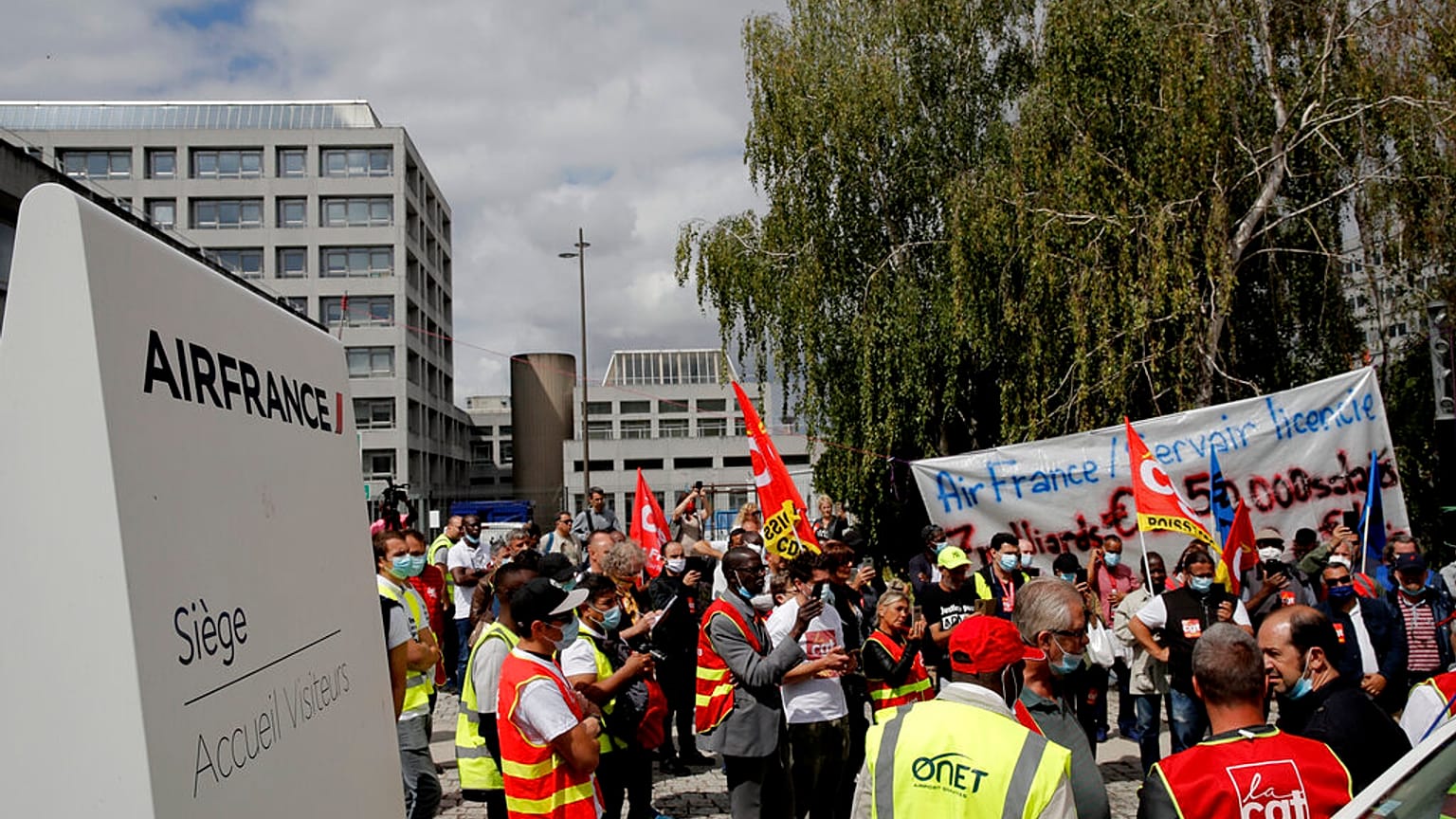 Air France workers gather during a protest in front of the company headquarters in Tremblay-en-France, outside Paris.