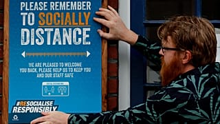 A pub owner put signs in place instructing on social distancing at the Chandos Arms pub in London, Wednesday, July 1, 2020.