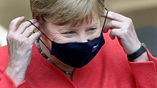 German Chancellor Angela Merkel adjusts her face mask as she arrives for a meeting of the upper house of the German legislative in Berlin, Germany, Friday, July 3, 2020.