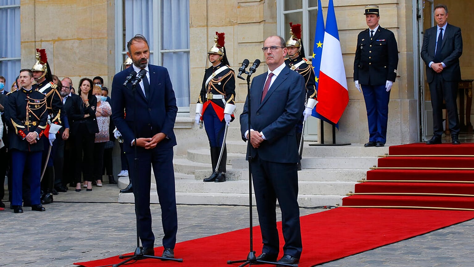 Outgoing French Prime Minister Edouard Philippe, left, speaks while newly named Prime Minister Jean Castex listens after the handover ceremony in Paris.