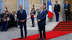 Outgoing French Prime Minister Edouard Philippe, left, speaks while newly named Prime Minister Jean Castex listens after the handover ceremony in Paris.