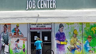 a person looks inside the closed doors of the Pasadena Community Job Center in Pasadena, Calif., during the coronavirus outbreak, May 7, 2020 (file)