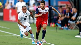 FC Dallas defender Ryan Hollingshead plays the ball while Minnesota United forward Miguel Ibarra chases him during the first half of an MLS soccer match in Frisco, Texas.