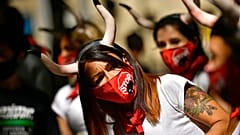 Demonstrators wear faces masks while protesting against San Fermin's bullfighting, canceled this year by the conoravirus pandemic, in Pamplona, northern Spain, Tuesday, July 7