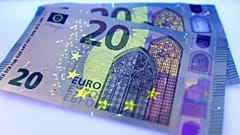 Two new 20 Euro bank notes are photographed under black light in Frankfurt, Germany