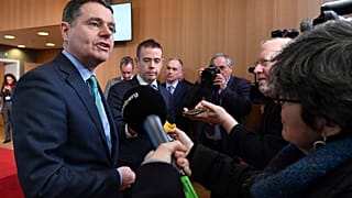 Irish Finance Minister Paschal Donohoe, left, speaks with the media prior to a meeting of the eurogroup at the EU Council building in Brussels on Monday, Feb. 19, 2018.
