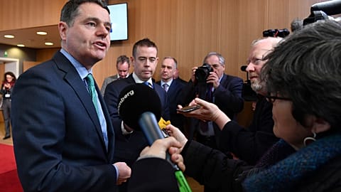 Irish Finance Minister Paschal Donohoe, left, speaks with the media prior to a meeting of the eurogroup at the EU Council building in Brussels on Monday, Feb. 19, 2018.