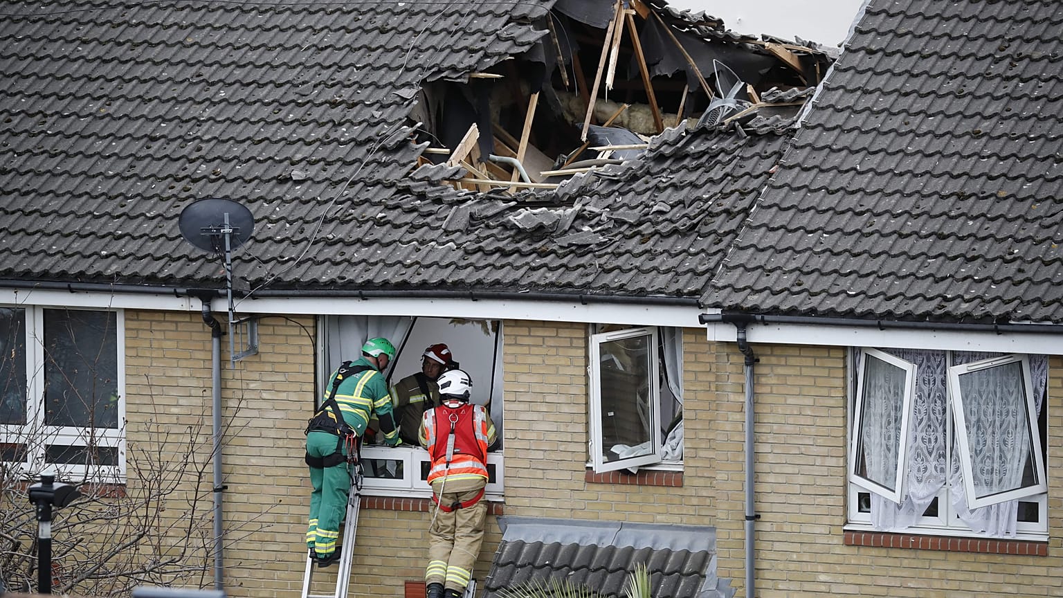 Members of London Fire Brigade assess the damage to a property in Bow, east London on July 8, 2020.
