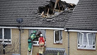 Members of London Fire Brigade assess the damage to a property in Bow, east London on July 8, 2020.