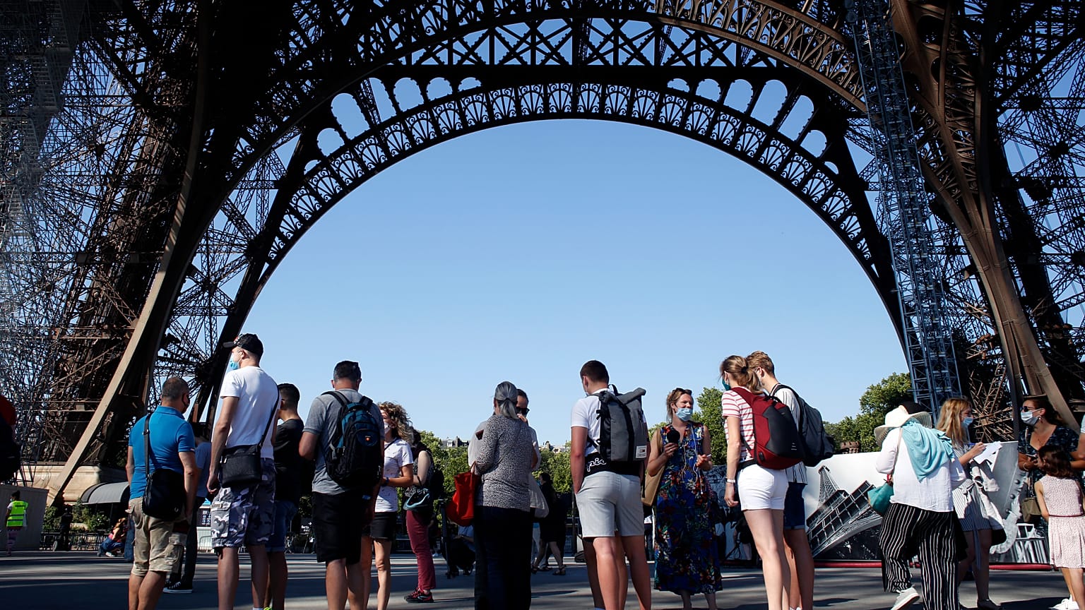People queue up prior to visit the Eiffel Tower, in Paris, Thursday, June 25, 2020. 