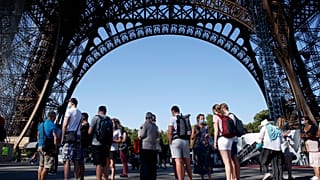 People queue up prior to visit the Eiffel Tower, in Paris, Thursday, June 25, 2020. 