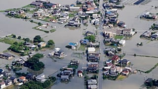 This aerial photo shows the flooded area caused by the swollen Chikugo River, not seen in photo, in Kurume city