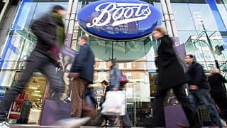 FILE - In this Oct. 5, 2005 file photo, people walk past a Boots pharmacy in central London.
