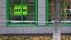 Russian state-owned television station RT logo is seen at the window of the company's office in Moscow, Russia, Friday, Oct. 27, 2017.