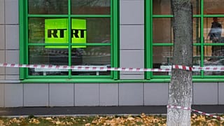 Russian state-owned television station RT logo is seen at the window of the company's office in Moscow.