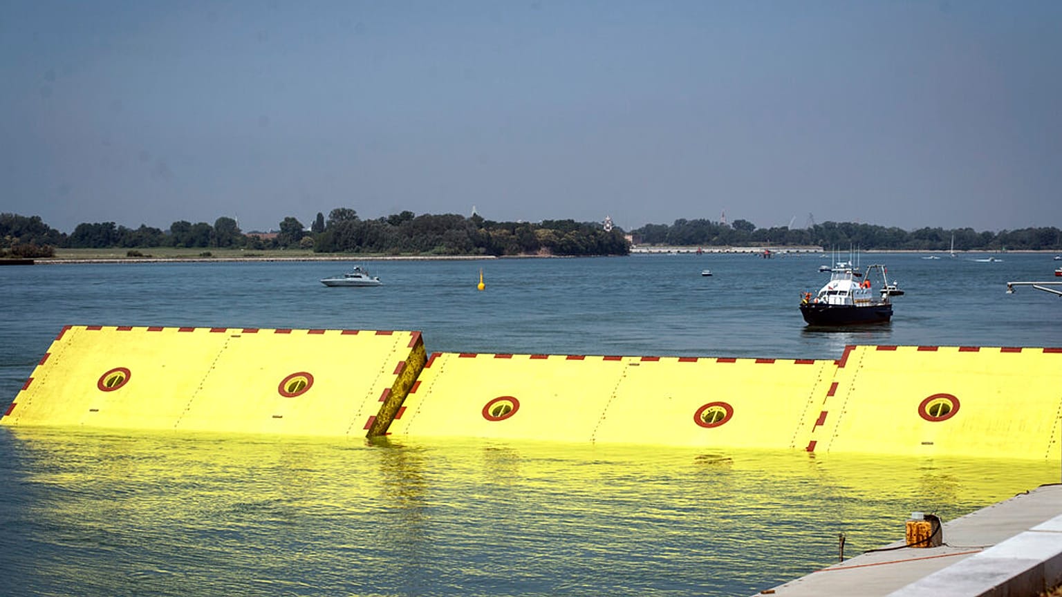 Moveable flood gates rise from the sea in the Venice lagoon, Italy, Friday, July 10, 2020. 