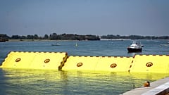 Moveable flood gates rise from the sea in the Venice lagoon, Italy, Friday, July 10, 2020. 