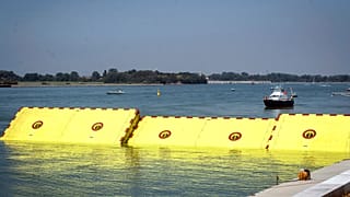 Moveable flood gates rise from the sea in the Venice lagoon, Italy, Friday, July 10, 2020. 