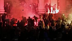 Protesters clash with riot police on the steps of the Serbian parliament during a protest in Belgrade, Serbia, Friday, July 10 2020. 