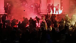 Protesters clash with riot police on the steps of the Serbian parliament during a protest in Belgrade, Serbia, Friday, July 10 2020. 