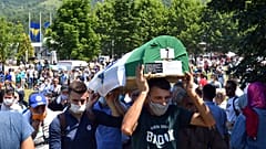 Bosnian Muslim men carry the casket of a newly identified victim during a burial ceremony marking the 25th anniversary of the Srebrenica massacre, Potocari, Bosnia, 11/7/20. 