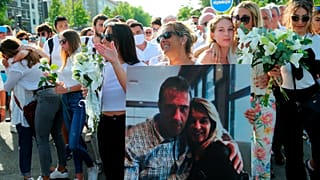 Veronique Monguillot holds a photo of her with her husband during a protest march in Bayonne