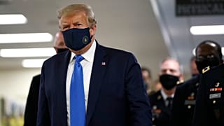 President Donald Trump wears a face mask as he walks down a hallway during a visit to Walter Reed National Military Medical Center in Bethesda, Md., Saturday, July 11, 2020.