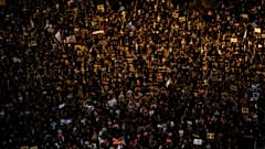 Protesters hold signs during a demonstration against Israel's government in Rabin square in Tel Aviv, Israel, Saturday, July 11, 2020.