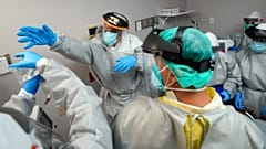 Dr. Joseph Varon reaches for an IV bag inside the Coronavirus Unit at United Memorial Medical Center in Houston, USA. July 6, 2020 