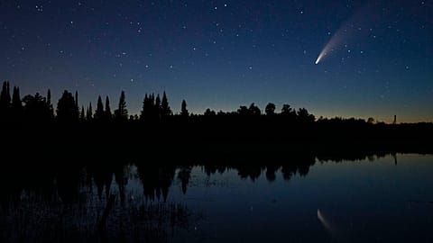 Comet Neowise streaks across the night sky over Wolf Lake in Brimson, Minnesota, USA. July 14, 2020