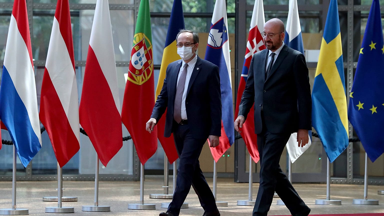 European Council President Charles Michel, right, walks with Kosovo's Prime Minister Avdullah Hoti before a meeting in Brussels in June