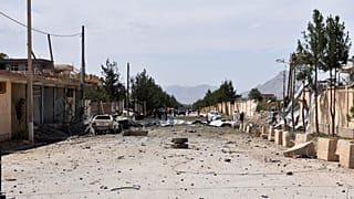 Afghan security personnel inspect the site of a car bomb blast on an intelligence compound in Aybak, northern Afghanistan, Monday, July 13, 2020.